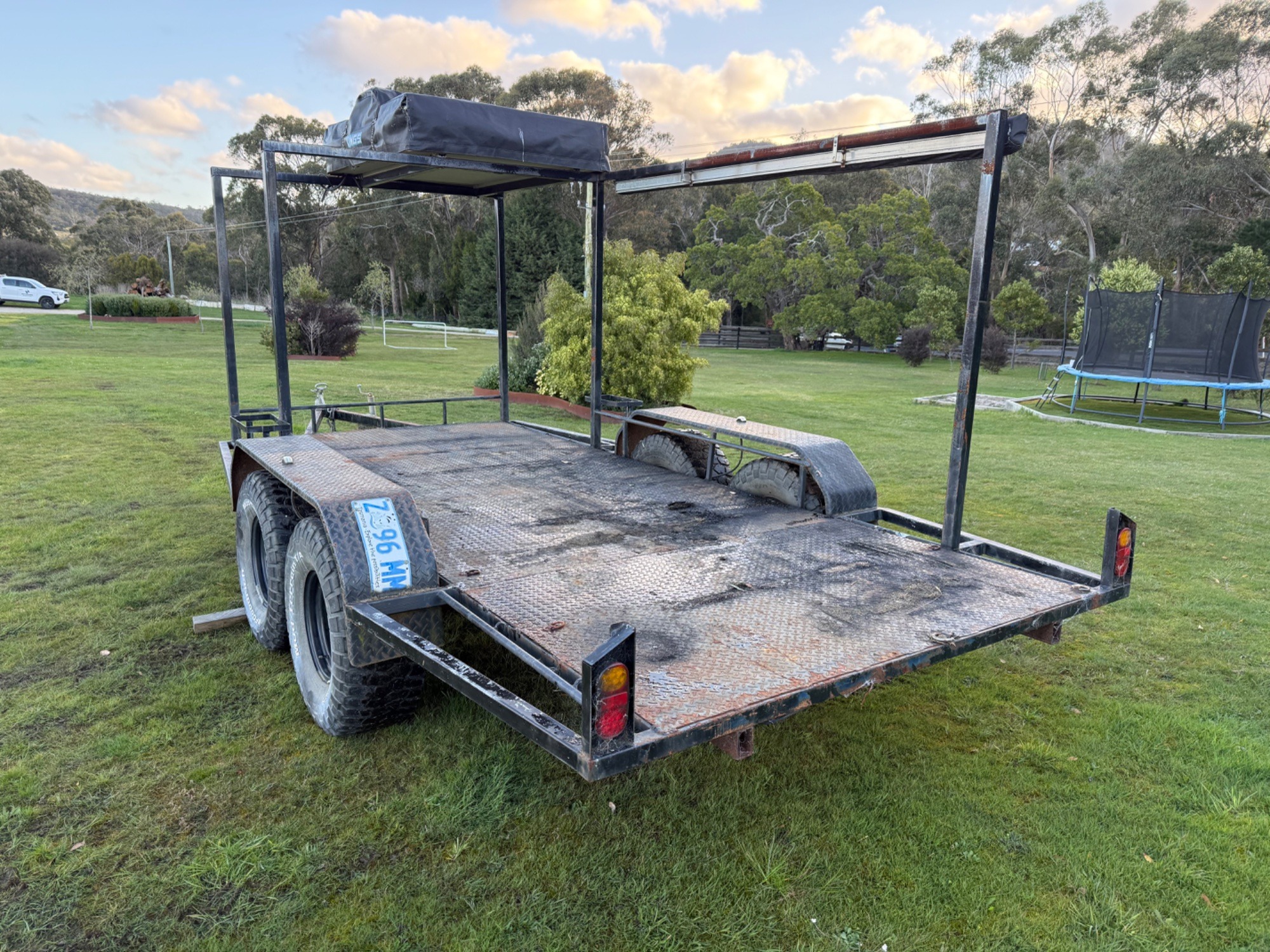 2009 Flatbed tandem trailer with kings rooftop tent,awning,Jerry can holder Custom black