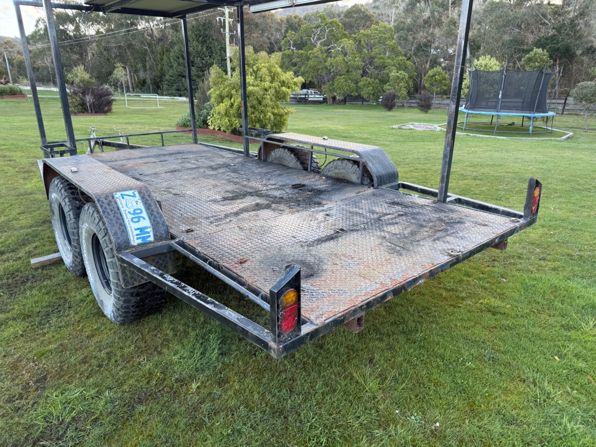 2009 Flatbed tandem trailer with kings rooftop tent,awning,Jerry can holder Custom black